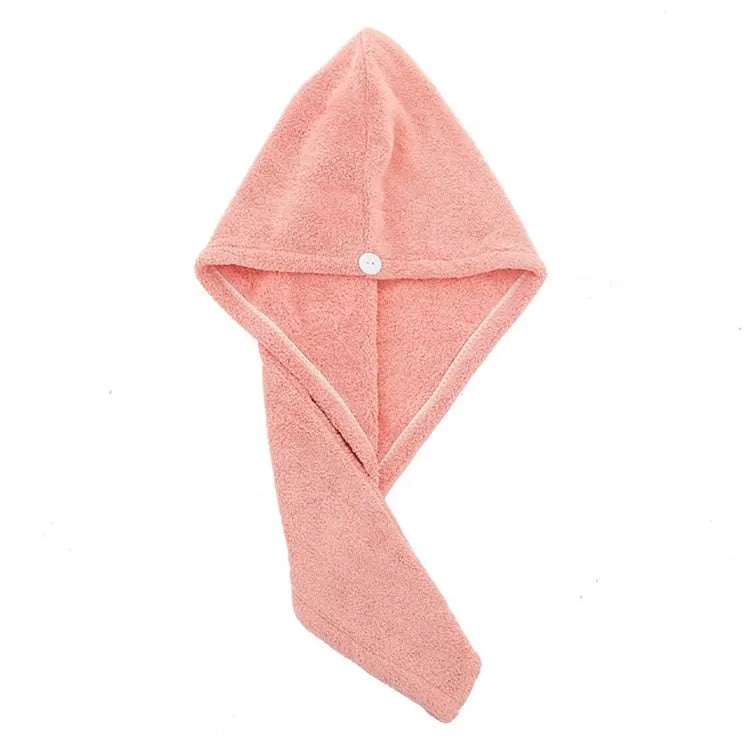 Serviette de séchage des cheveux. Une serviette couleur saumon étalée on voit bien la forme de la capuche et le bouton